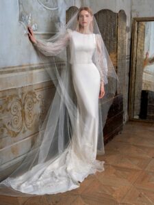 Fit and flare wedding dress with long balloon sleeves and open back