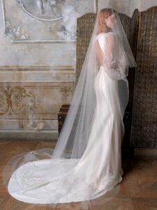 Fit and flare wedding dress with long balloon sleeves and open back