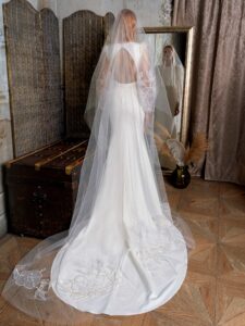Fit and flare wedding dress with long balloon sleeves and open back