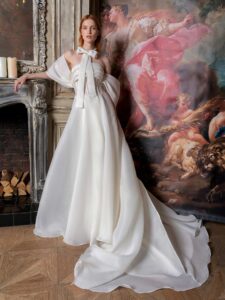 Off-the-shoulder A-line wedding dress with a draped bustier bodice