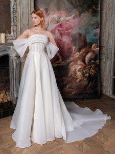 Off-the-shoulder A-line wedding dress with a draped bustier bodice