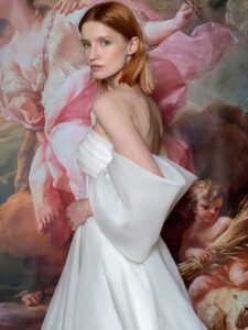Off-the-shoulder A-line wedding dress with a draped bustier bodice