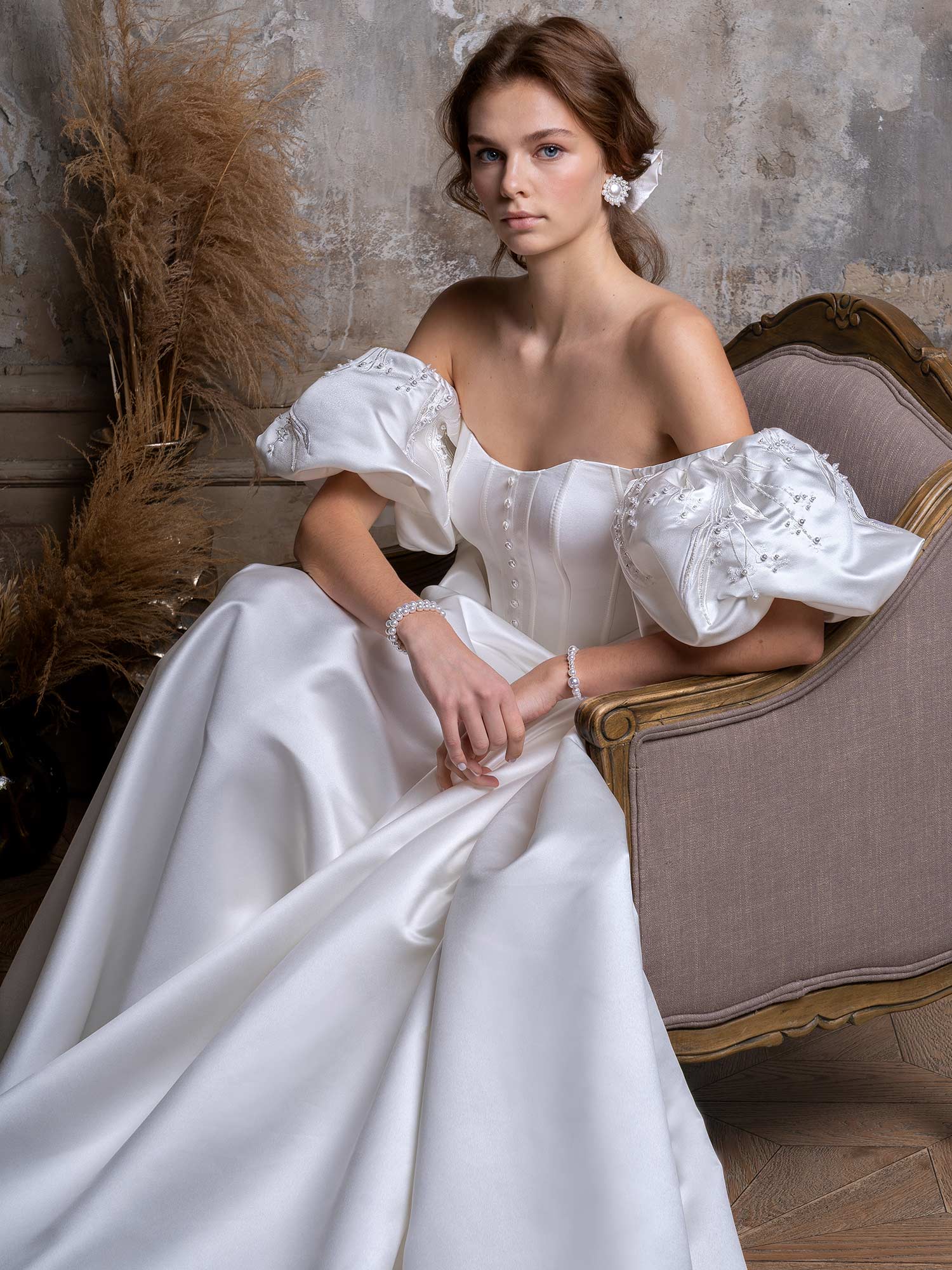 Style #2327L, off-the-shoulder A-line wedding dress with short puff sleeves and pockets; available in ivory