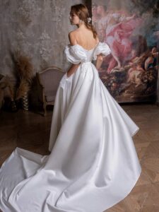 Off-the-shoulder A-line wedding dress with short puff sleeves and pockets