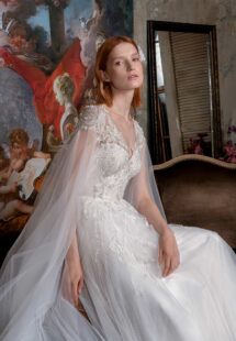 Style #2328L, V-neck A-line wedding gown with cape sleeves and floral embroidery; available in ivory