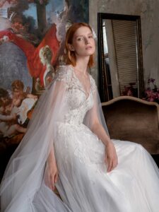 V-neck A-line wedding gown with cape sleeves and floral embroidery