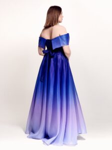 Style #738b, evening gown with an off-the-shoulder neckline and bow decor; available in midi or maxi length; in lavender or emerald