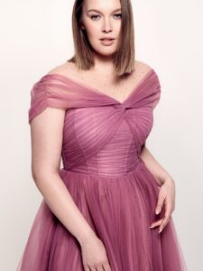 Style #742а, tulle A-line cocktail dress with off-the-shoulder straps, pleated corset and beaded illusion neckline; available in midi or maxi length; in pink, purple, blue, cherry, powder pink, black or ivory