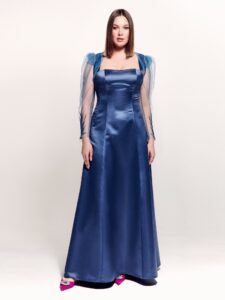 Style #745, square neck evening gown with thick straps, corset back, and removable long-sleeve bolero with floral decor; available in steel-dark blue, black, eggplant, crimson or ivory