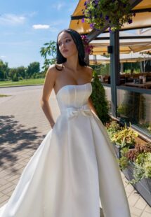 Style #15003, satin A-line wedding dress with a slit and pockets; available in ivory