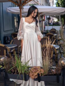 Long-sleeved wedding dress with butterfly decor; available in ivory, ivory-peach