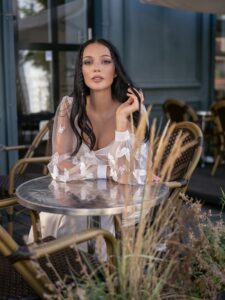 Long-sleeved wedding dress with butterfly decor; available in ivory, ivory-peach
