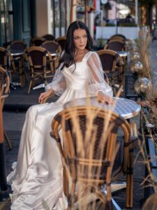 Long-sleeved wedding dress with butterfly decor; available in ivory, ivory-peach