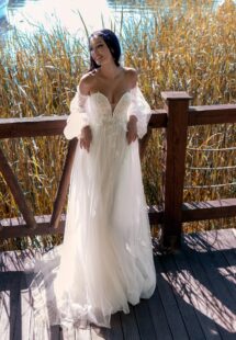 Style #15006, A-line wedding dress with 3D butterfly decor and detached bishop sleeves; available in ivory