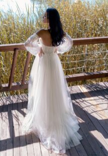 Style #15006, A-line wedding dress with 3D butterfly decor and detached bishop sleeves; available in ivory