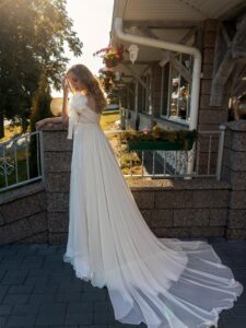 High-waisted wedding dress with an off-the-shoulder neckline and floral straps
