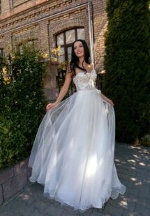 Style #15011, strapless A-line wedding dress with a bustier bodice and floral applique; available in ivory