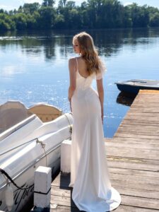 Sheath wedding dress with a slit and ruffles