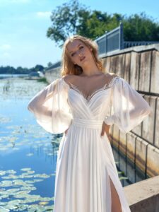Long-sleeved chiffon wedding gown with an off-the-shoulder neckline