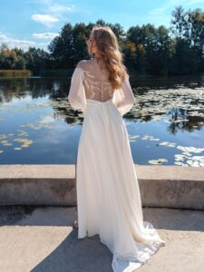 Long-sleeved chiffon wedding gown with an off-the-shoulder neckline