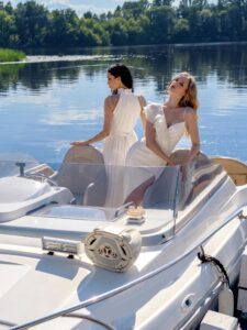 Halter neck sheath wedding dress with long sleeves and pearls; Sheath wedding dress with a slit and ruffles