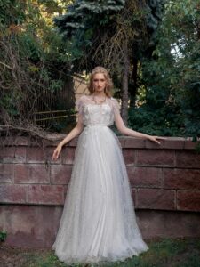 Lace A-line wedding dress with illusion neckline, flowers and butterfly decor