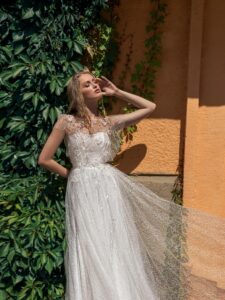 Lace A-line wedding dress with illusion neckline, flowers and butterfly decor