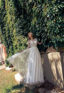 Style #15020, lace A-line wedding dress with illusion neckline, flowers and butterfly decor; available in ivory