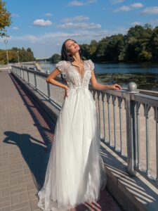 V-neck A-line wedding dress with cap sleeves and open back