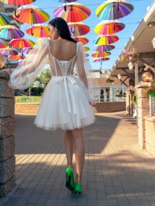 Short wedding dress with a puffy skirt and long sleeves