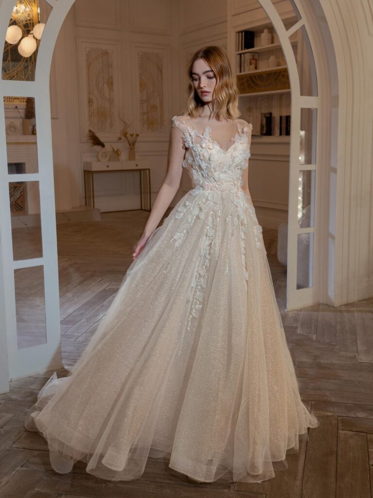 Style #2400L, A-line wedding dress with 3D floral decor; available in peach, cream