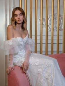 Strapless fit and flare wedding dress with long off-the-shoulder sleeves