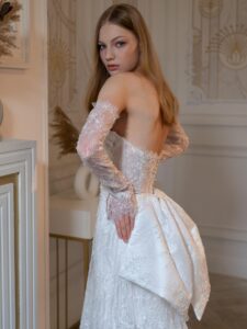 Beaded sheath wedding gown with detachable long sleeves and accent bow