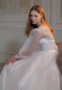 Style #2406L, sequinned A-line wedding dress with detachable long-sleeved overlay blouse; available in peach, ivory