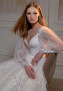 Style #2406L, sequinned A-line wedding dress with detachable long-sleeved overlay blouse; available in peach, ivory