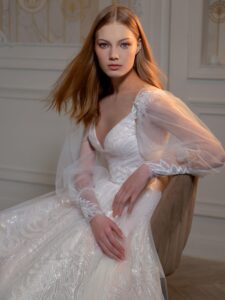 Sequinned A-line wedding dress with detachable long-sleeved overlay blouse; available in peach, ivory