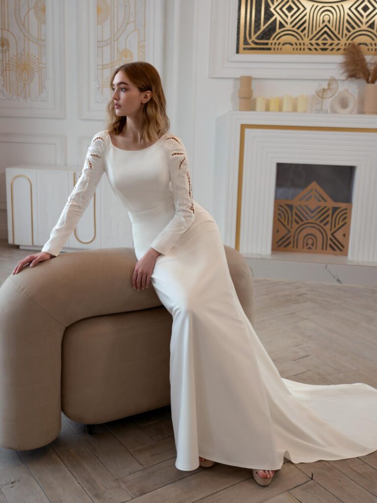 Style #2411L, plain wedding dress with long sleeves and open back; available in ivory