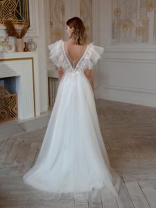High-low A-line wedding dress with feathers and beads; available in cream