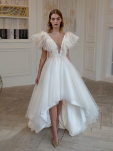 High-low A-line wedding dress with feathers and beads; available in cream