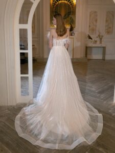 Illusion-neck ball gown wedding dress with sequins, feathers and beads; available in ivory-peach