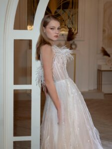 Illusion-neck ball gown wedding dress with sequins, feathers and beads; available in ivory-peach