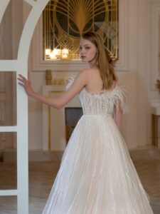 Illusion-neck ball gown wedding dress with sequins, feathers and beads; available in ivory-peach