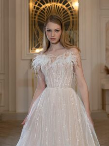 Illusion-neck ball gown wedding dress with sequins, feathers and beads; available in ivory-peach