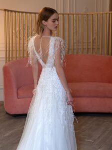 V-neck wedding dress with beads, feathers, and open back