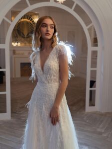 V-neck wedding dress with beads, feathers, and open back