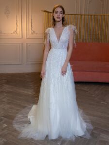 V-neck wedding dress with beads, feathers, and open back