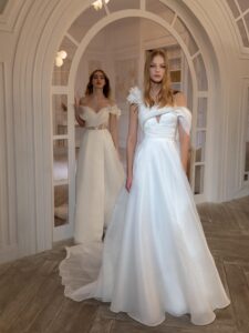 Organza A-line wedding dress with 3D flower decor and one-shoulder strap; Organza off-the-shoulder A-line wedding dress with a slit