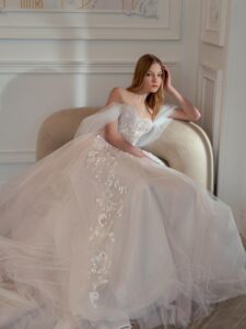 A-line wedding dress with off-the-shoulder straps and floral embroidery; available in ivory-pink