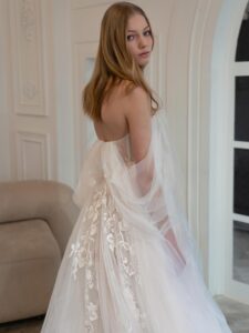 A-line wedding dress with off-the-shoulder straps and floral embroidery; available in ivory-pink