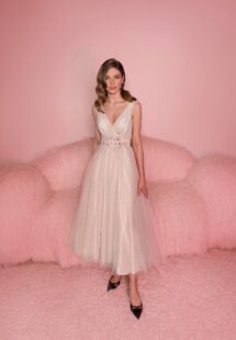 Style #804, polka dot tulle A-line dress with flower decor; available in midi or floor length; in powder (shown online) or cream